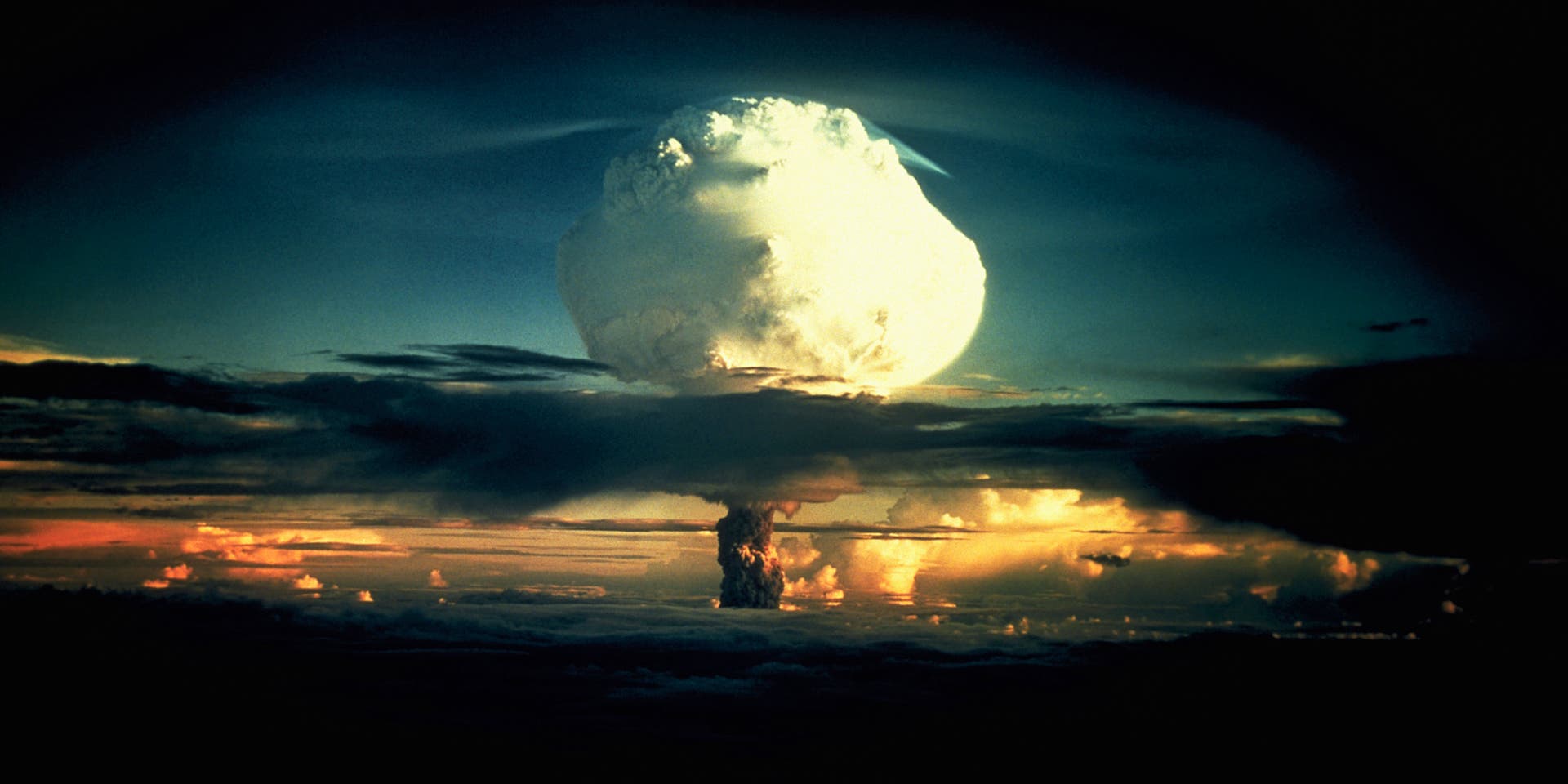 Operation Ivy Hydrogen Bomb Test in Marshall Islands A billowing white mushroom cloud, mottled with orange, pushes through a layer of clouds during Operation Ivy, the first test of a hydrogen bomb, at Enewetak Atoll in the Marshall Islands. (Photo by © CORBIS/Corbis via Getty Images)