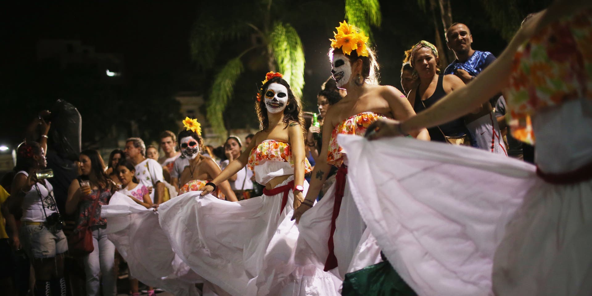 Rio Celebrates Dia De MuertosRIO DE JANEIRO, BRAZIL - NOVEMBER 01: Revelers dance during a Day of the Dead party on November 1, 2015 in Rio de Janeiro, Brazil. Brazilians often mark the traditional Mexican holiday by visiting loved ones' graves and sometimes leaving offerings of food or drink. The day officially falls tomorrow in Brazil and is a national holiday. (Photo by Mario Tama/Getty Images)