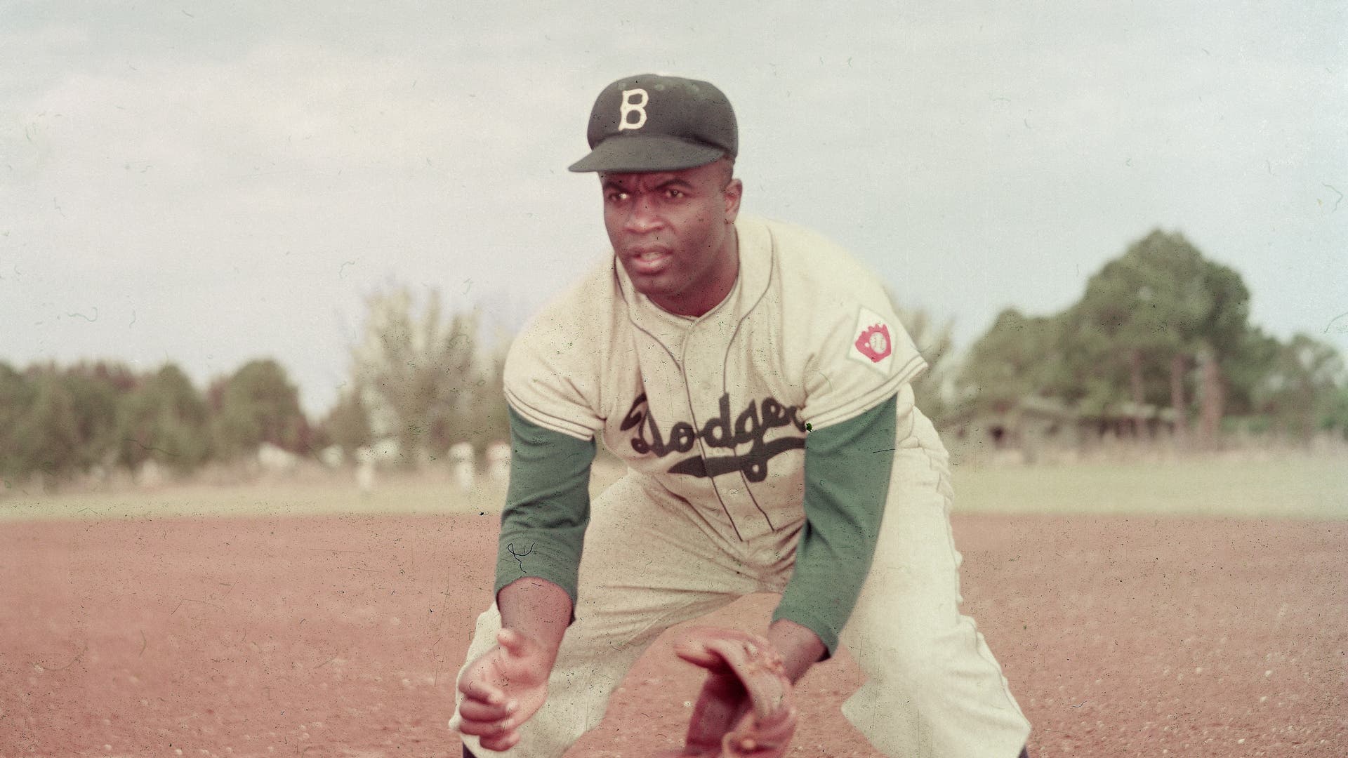 Jackie Robinson In ActionAmerican professional baseball player Jackie Robinson (1919 - 1972) of the Brooklyn Dodgers, dressed in a road uniform, crouches by the base and prepares to catch a ball, 1951. Throughout the course of his baseball career Robinson played several positions on the infield as well as serving as outfielder. (Photo by Keystone/Getty Images)