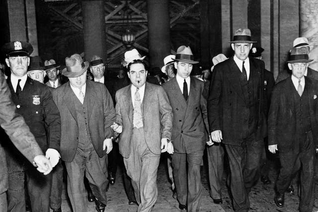 Salvatore Lucania, called Lucky Luciano (1897-1962), gangster of sicilian mafia (with handcuffs and cigaret) leaving the court in New York on june 18, 1936 UNSPECIFIED : Salvatore Lucania, called Lucky Luciano (1897-1962), gangster of sicilian mafia (with handcuffs and cigaret) leaving the court in New York on june 18, 1936 (Photo by Apic/Getty Images)