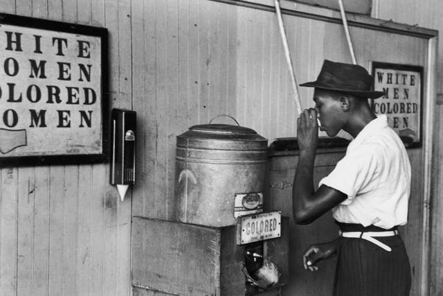 Segregated FountainJuly 1939: An African-American man drinking at a segregated drinking fountain in Oklahoma City, Oklahoma. (Photo by Russell Lee/Library Of Congress/Getty Images)