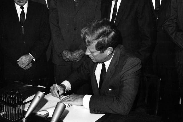President John F Kennedy signs the instruments of ratification of the limited Nuclear Test Ban Treaty at the White House, Washington DC, October 7, 1963.