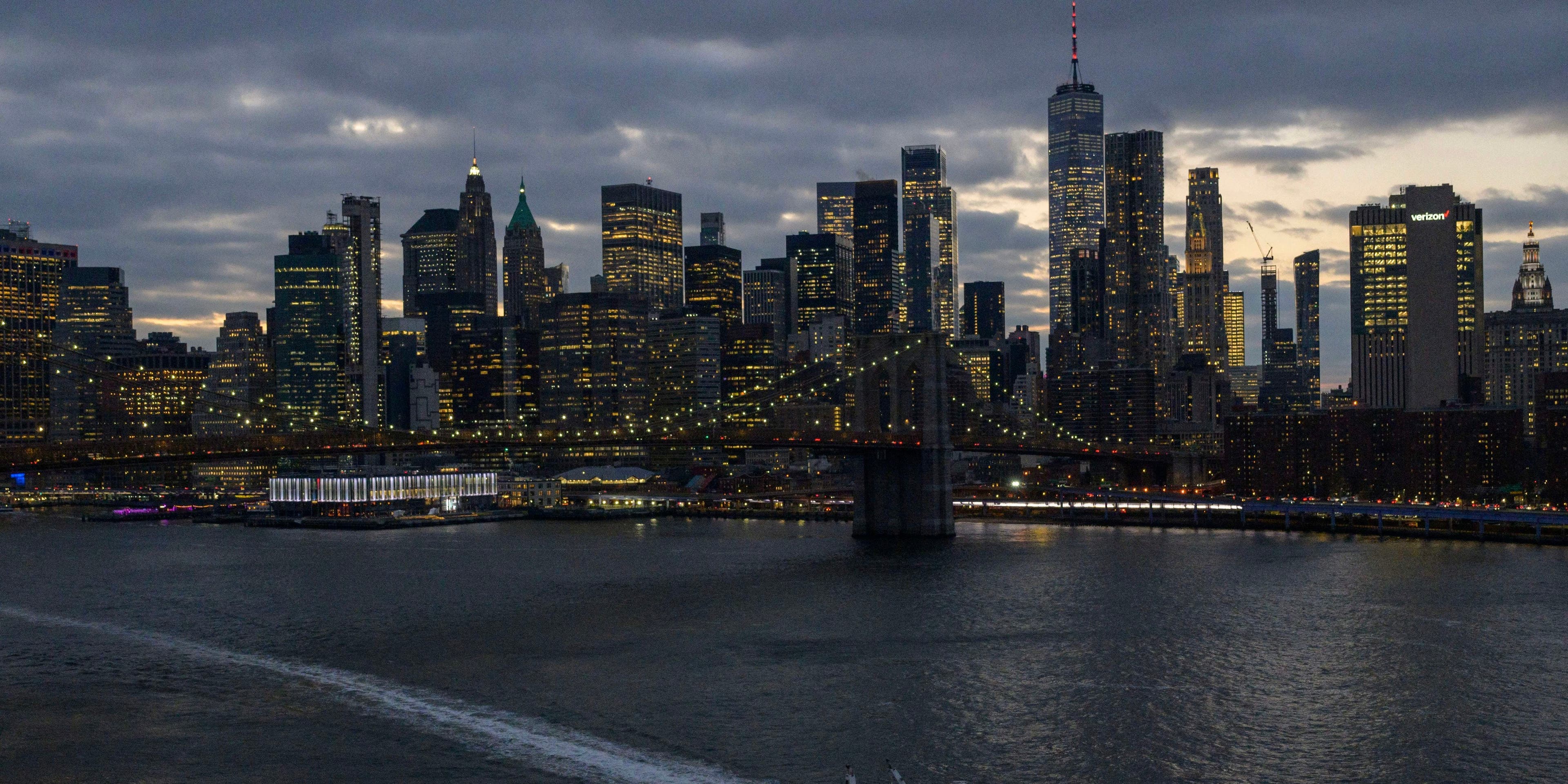 The skyline of lower Manhattan is seen past a ferry on the East River in New York City on February 06, 2023.