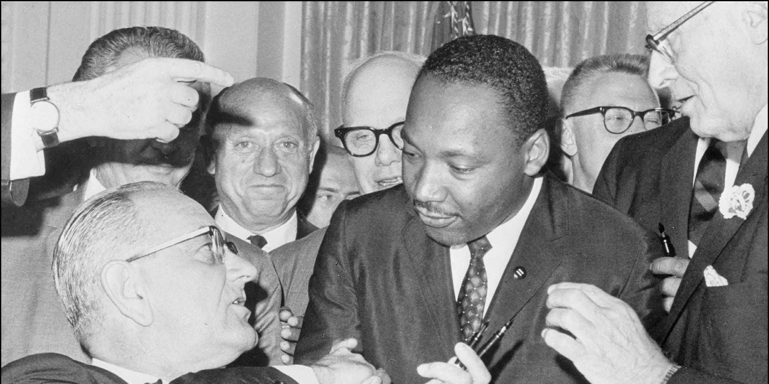 Martin Luther King Jr. shakes hands with President Lyndon B. Johnson at the signing of the 1964 Civil Rights Act.