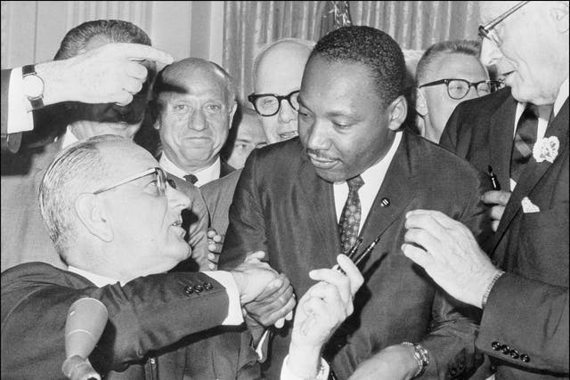 Martin Luther King Jr. shakes hands with President Lyndon B. Johnson at the signing of the 1964 Civil Rights Act.