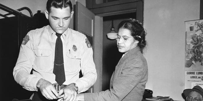 Rosa Parks being fingerprinted by police after refusing to give up her seat on the bus to a white man.