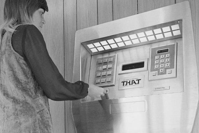 Jaynee Hurd demonstrates the first automated teller machine at the Los Angeles branch of the Bank of California. Named