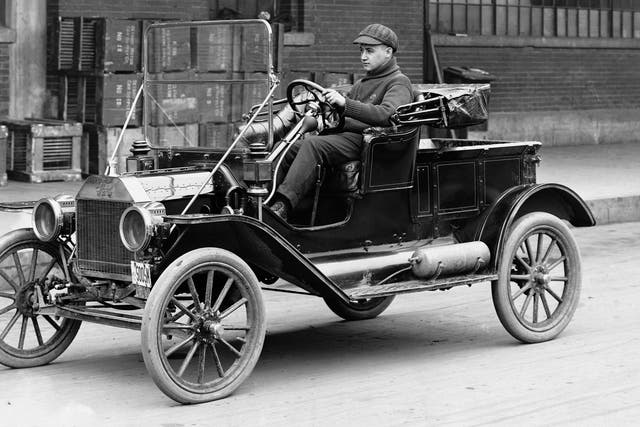 Man Driving Ford Model T A man drives a Ford Model T automobile in the 1920