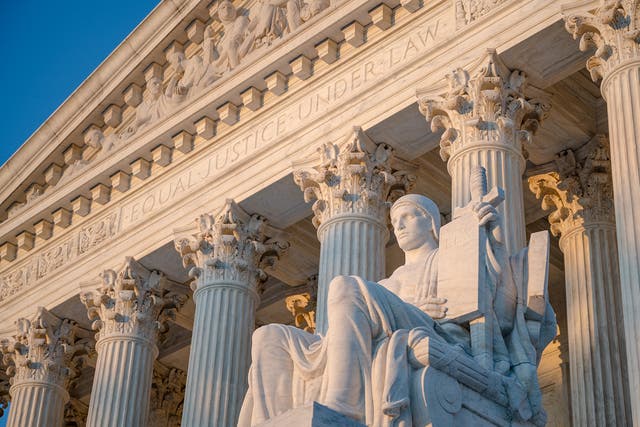 Exterior of Supreme Court of the United States on First Street in Washington, D.C., with statue by James Earle Fraser titled Authority of Law.