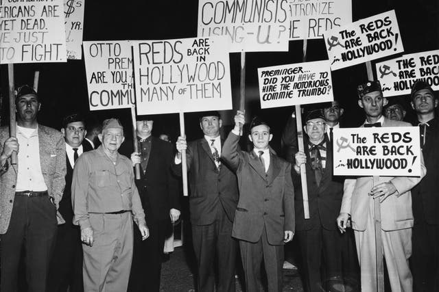 A group of protesters demonstrate holding placards against Communist sympathizers outside the Fox Wilshire Theatre in occasion of the premiere of film 'Exodus', which marked the end of the 'Hollywood Blacklist' when screen player Dalton Trumbo, a Communist Party member from 1943 to 1948 and member of the Hollywood Ten, was credited as the screenwriter of the film, Beverly Hills, Los Angeles, California, US, December 1960. (Photo by American Stock Archive/Archive Photos/Getty Images)