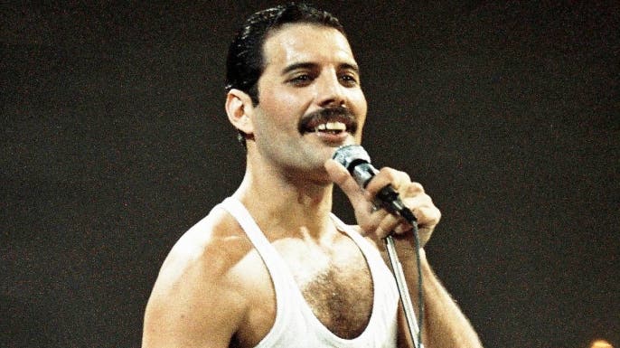 Freddie Mercury of Queen performs on stage at Live Aid on July 13th, 1985.
