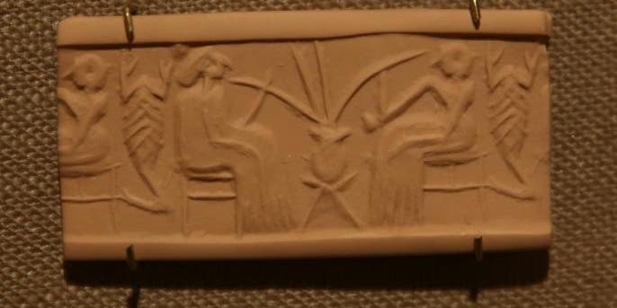 A clay seal depicting beer drinking in a banquet scene dating from 2600-2350 B.C.