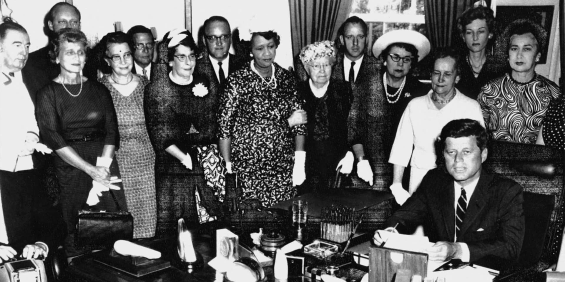 US-WHITE HOUSE-KENNEDY Standing behind President John F. Kennedy (Seated-R) signing the Equal Pay Act on 10 June 1963 from (R-L) are: Congresswoman Edna Kelly, Congresswoman Edith Green, an unidentified woman, Mary Anderson, Women's Bureau Director, and Dr. Dorothy Height, President National Council of Negro Women. Other organizations represented at this event included the National Council of Catholic Women, the National Council of Jewish Women, the United Auto Workers, and the National Federation of Business and Professional Women's Clubs. AFP PHOTO/HO (Photo by - / John F. Kennedy Library Foundation / AFP) (Photo by -/John F. Kennedy Library Foundati/AFP via Getty Images)