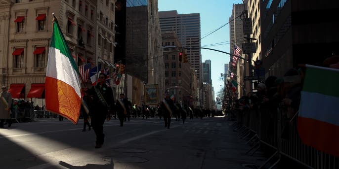 A participant of the annual St. Patrick's Day parade in New York City, which dates back to 1762, marches down 5th Avenue with an Irish flag. (Credit: Drew Angerer/Getty Images)