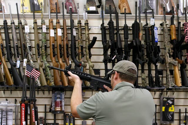 Inside A Gun And Ammunition Store As Debate About Gun Ownership Continues During U.S. Elections A customer holds a AR-15 riffle for sale at a gun store in Orem, Utah, U.S., on Thursday, Aug. 11, 2016. The constitutional right of Americans to bear arms has <a href=