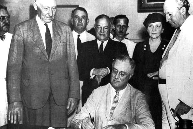 Franklin D. Roosevelt. United States President Franklin D. Roosevelt signing the Social Security Bill (Act) in 1935. (Photo by: Photo12/Universal Images Group via Getty Images)