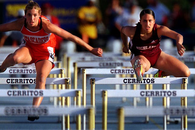Gina Londono, right, of Highland, makes her way to a third place (15.42) finish in the women's 100meter high hurdlesduring the CIF Southern Section Track and Field Masters Meet held Friday evening iat Cerritos College.
