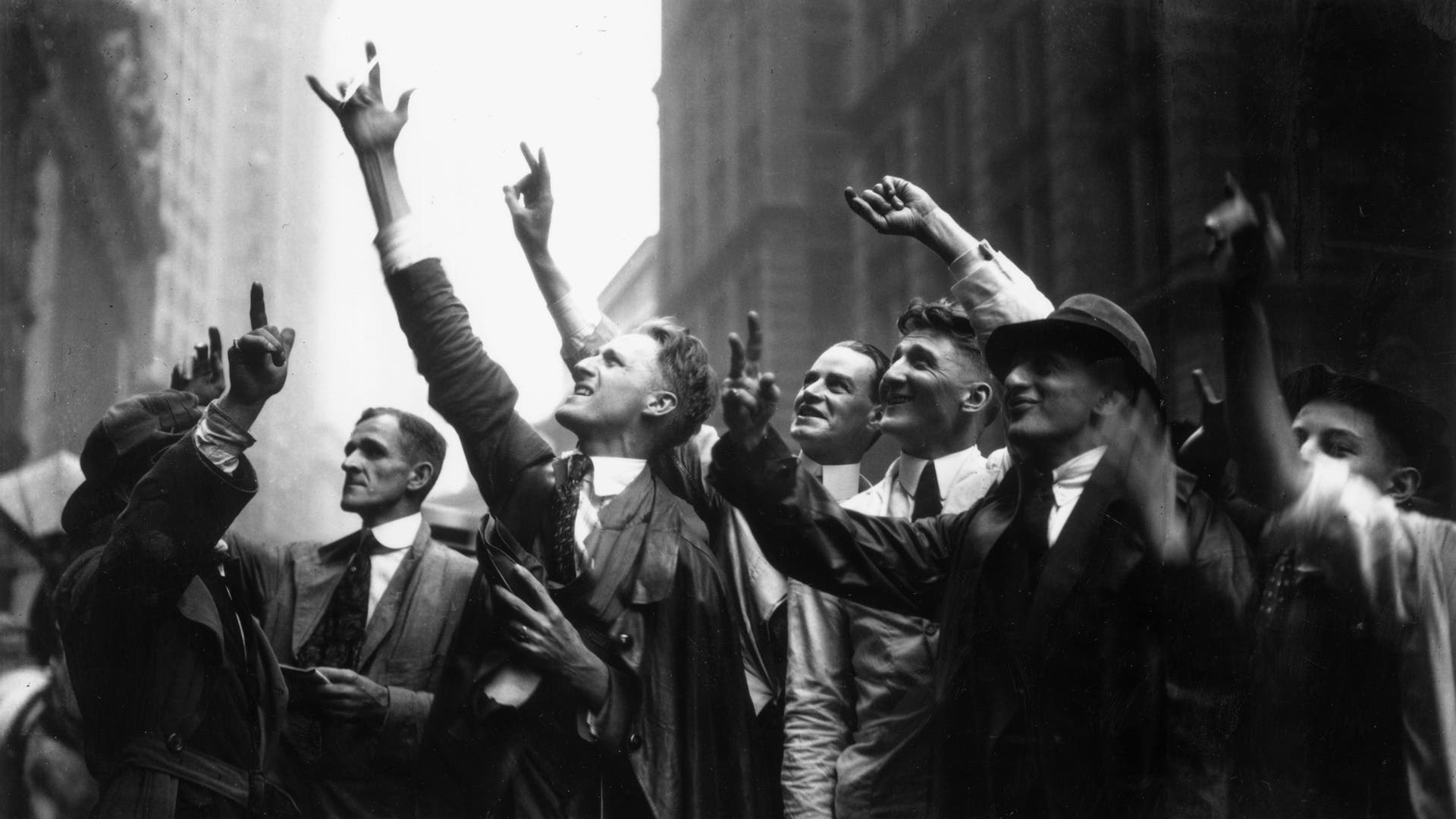 Curb Market traders gesture with their hands to trade stocks, on Wall Street, New York City, 1925.