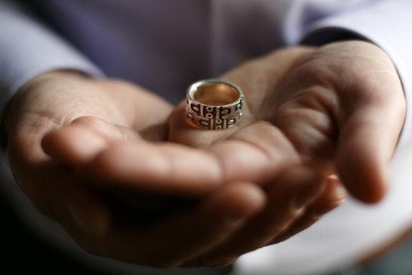 Jim Obergefell was married to his husband John Arthur on a medical jet in Maryland shortly before Arthur died of ALS. Obergefell holds his wedding band that has been fused together with Arthur's ashes and wedding ring. (Credit: Maddie McGarvey/For The Washington Post via Getty Images)