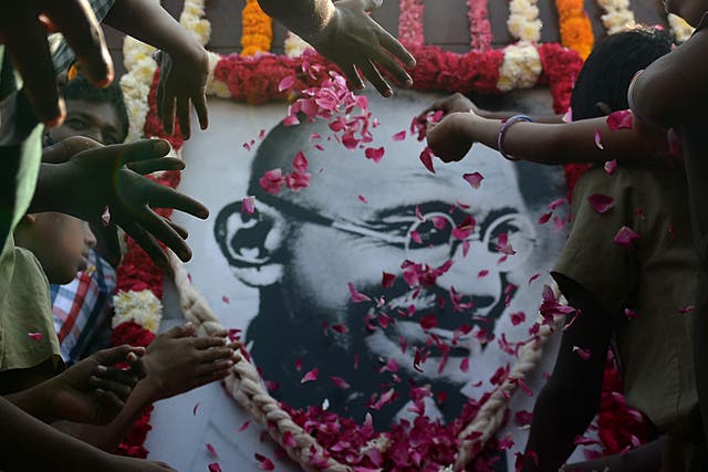 Indian school children pay homage to a portrait of Indian independence icon Mahatma Gandhi to mark the 70th anniversary of Gandhi's assassination. Gandhi was on the way to a prayer meeting in the Indian capital when he was shot three times in the chest and head on January 30, 1948.
