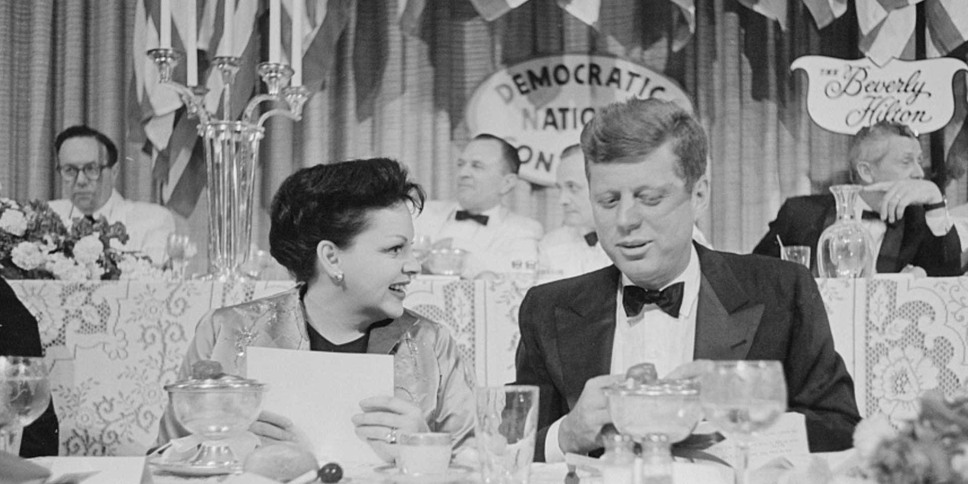 Judy Garland seated next to Senator John F. Kennedy